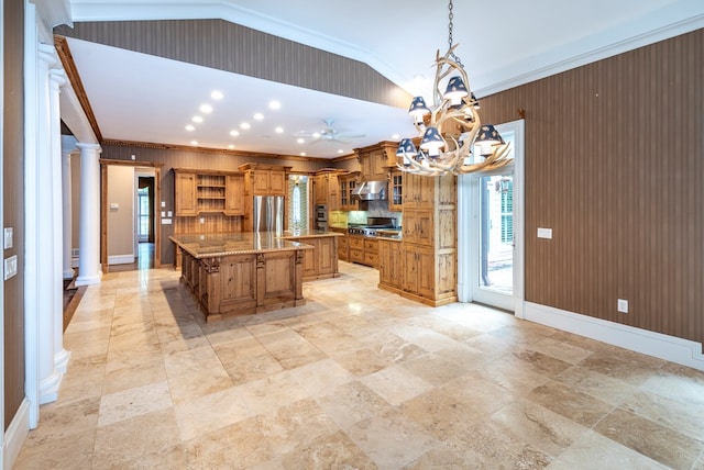 kitchen with a large island, hanging light fixtures, stainless steel appliances, tasteful backsplash, and decorative columns