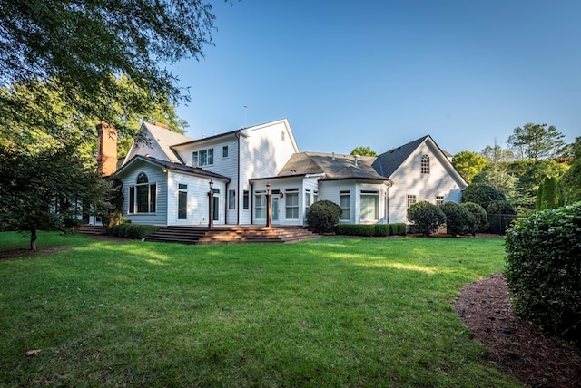 back of house with a lawn