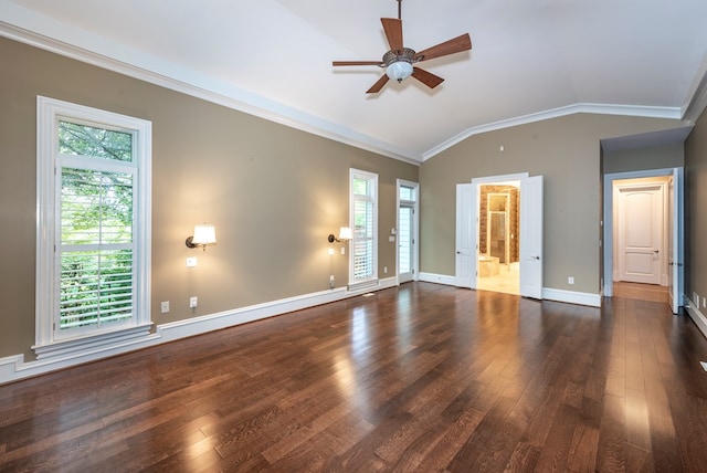 spare room featuring dark hardwood / wood-style flooring, vaulted ceiling, and ornamental molding