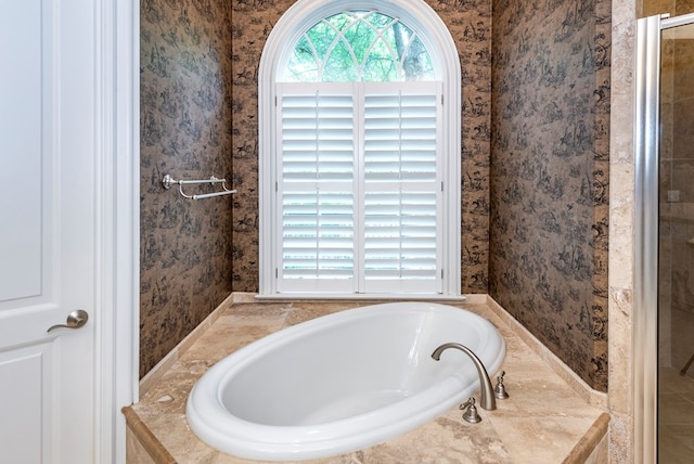 bathroom featuring tiled tub