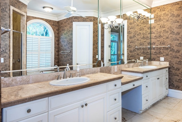 bathroom featuring ceiling fan with notable chandelier, ornamental molding, and vanity