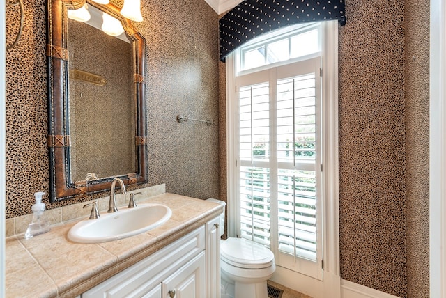 bathroom featuring vanity and toilet