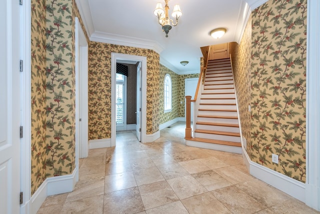 foyer entrance with a notable chandelier and crown molding