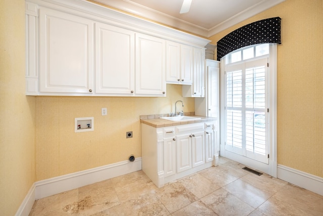 clothes washing area with cabinets, sink, hookup for a washing machine, ornamental molding, and hookup for an electric dryer