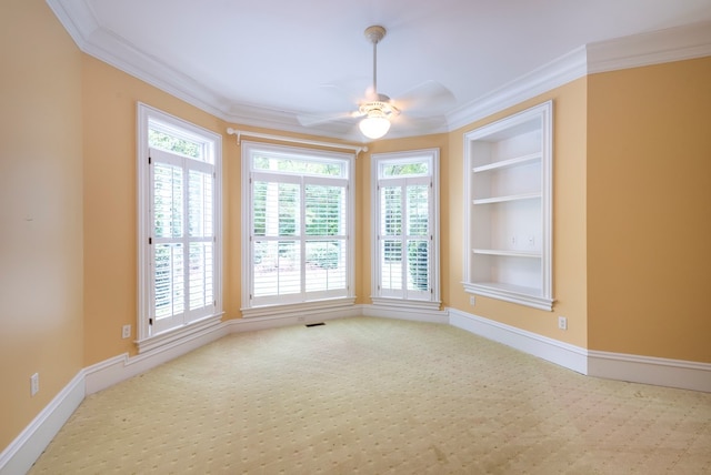 unfurnished room featuring built in shelves, ceiling fan, and ornamental molding