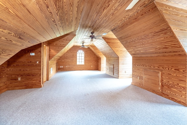 bonus room featuring wood ceiling, ceiling fan, wooden walls, carpet floors, and lofted ceiling