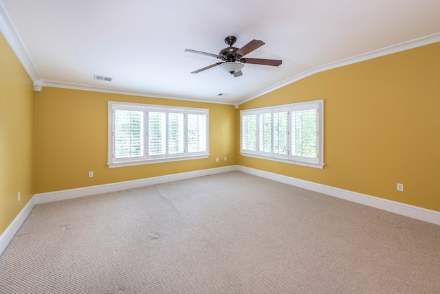 carpeted empty room with ceiling fan, vaulted ceiling, and ornamental molding