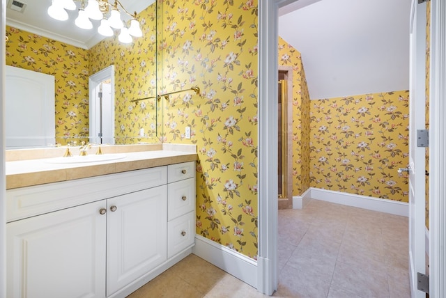 bathroom featuring tile patterned flooring, vanity, and crown molding