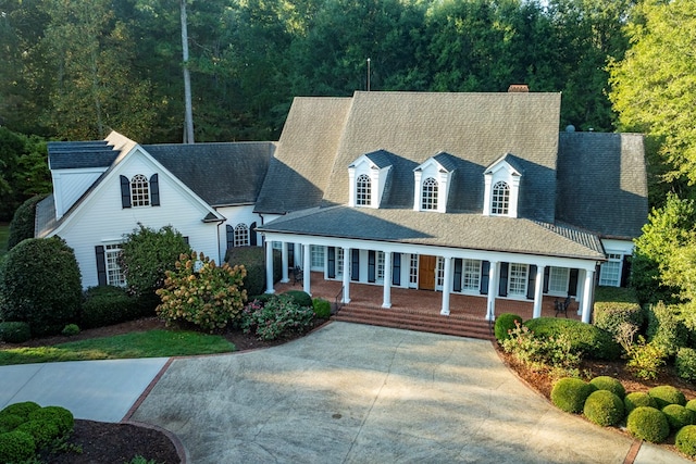 new england style home with covered porch