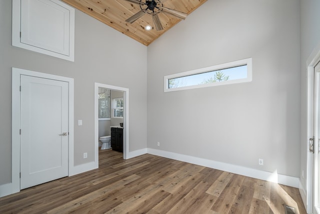 538 Mountain Laurel Rdg, Mineral Bluff, GA 30559 - unfurnished bedroom featuring high vaulted ceiling, baseboards, connected bathroom, and wood finished floors