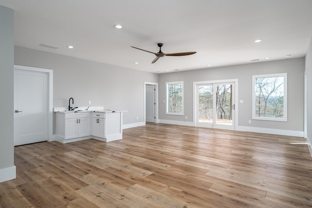 538 Mountain Laurel Rdg, Mineral Bluff, GA 30559 - unfurnished living room with a ceiling fan, light wood-style flooring, recessed lighting, baseboards, and a sink