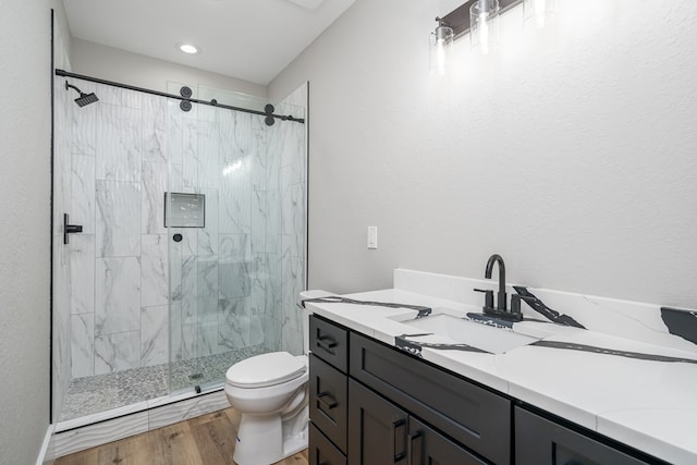 538 Mountain Laurel Rdg, Mineral Bluff, GA 30559 - bathroom featuring toilet, a marble finish shower, wood finished floors, and vanity