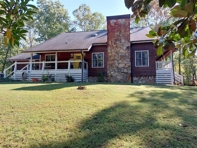 back of house with a lawn