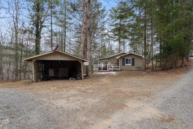 view of property exterior with an outbuilding and covered porch