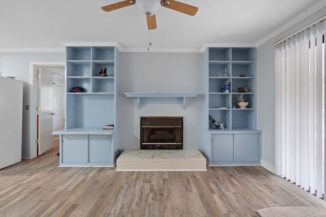 unfurnished living room with crown molding, ceiling fan, and light wood-type flooring