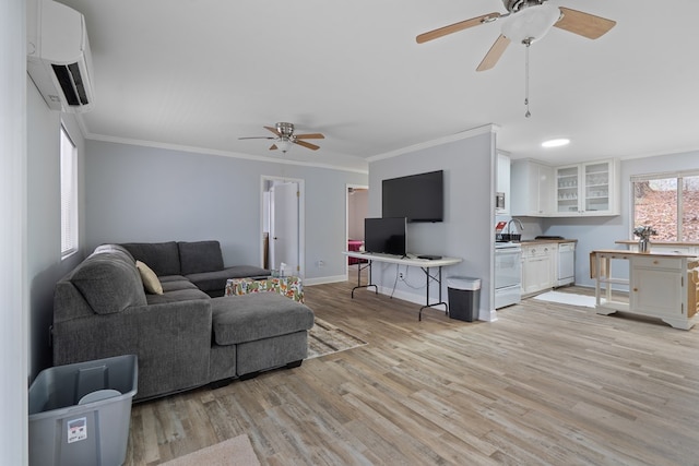 living room featuring ornamental molding, plenty of natural light, a wall unit AC, and light hardwood / wood-style floors