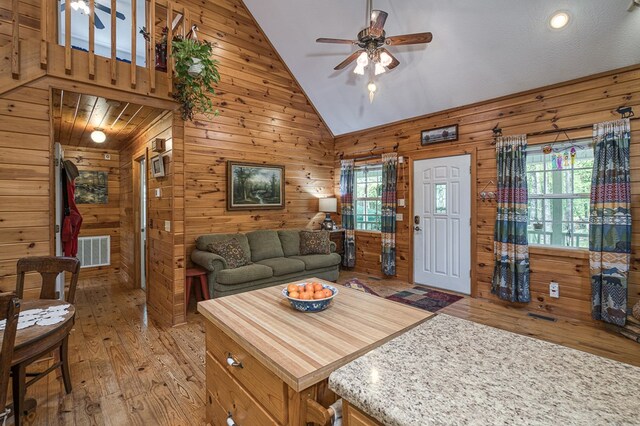 45 8 Point Trl, Blairsville, GA 30512 - living area featuring visible vents, wooden walls, high vaulted ceiling, light wood-type flooring, and a ceiling fan
