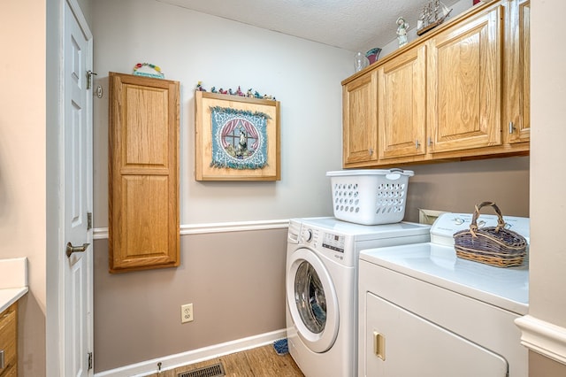 45 8 Point Trl, Blairsville, GA 30512 - laundry room with cabinet space, separate washer and dryer, a textured ceiling, light wood-type flooring, and visible vents