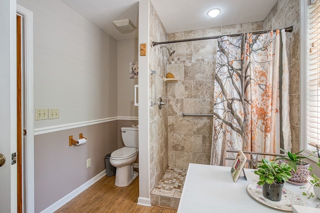 45 8 Point Trl, Blairsville, GA 30512 - full bath featuring a textured ceiling, wood finished floors, a tile shower, and toilet