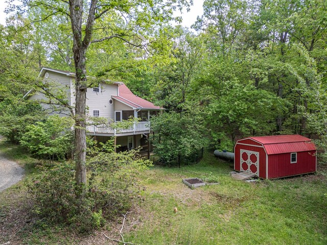 45 8 Point Trl, Blairsville, GA 30512 - view of yard featuring an outdoor structure, a deck, a shed, and a forest view