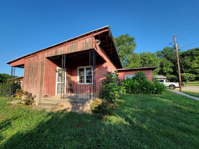 view of side of home featuring a yard