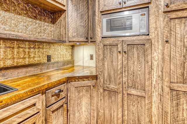 details with butcher block counters and white microwave