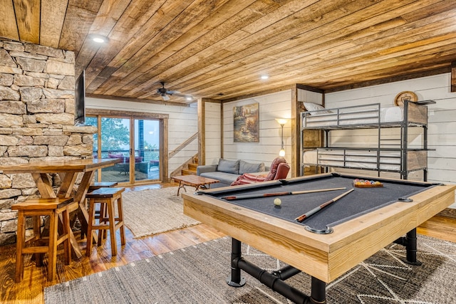 game room with wood-type flooring, wood walls, pool table, wooden ceiling, and a ceiling fan