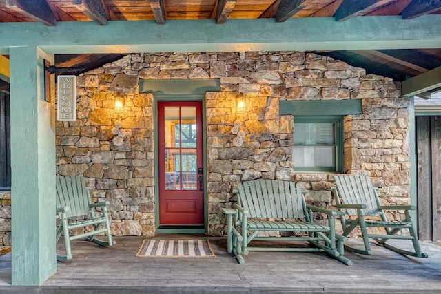 entrance to property featuring stone siding
