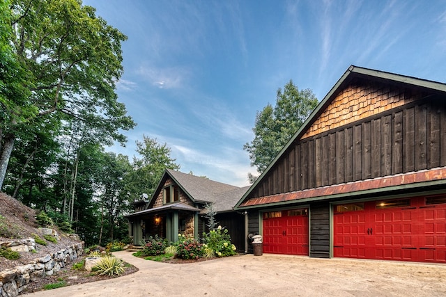 view of front of home with board and batten siding, driveway, and a garage