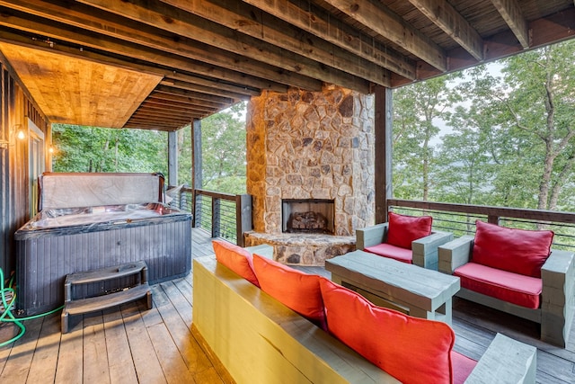 wooden terrace with a hot tub and an outdoor living space with a fireplace