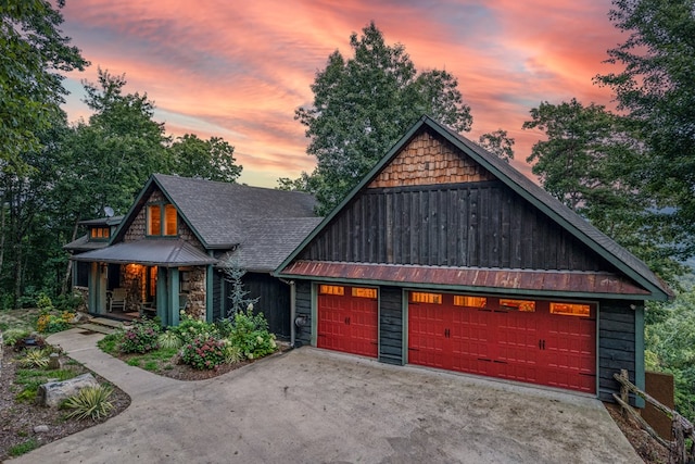 view of front of property with covered porch, board and batten siding, a standing seam roof, metal roof, and roof with shingles
