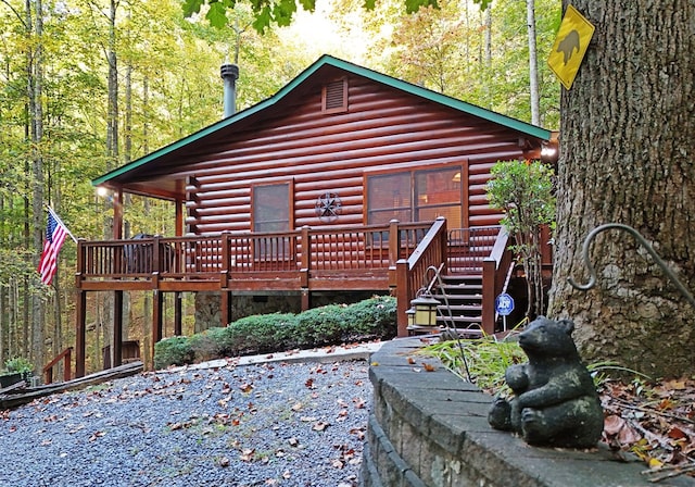 back of house featuring a wooden deck