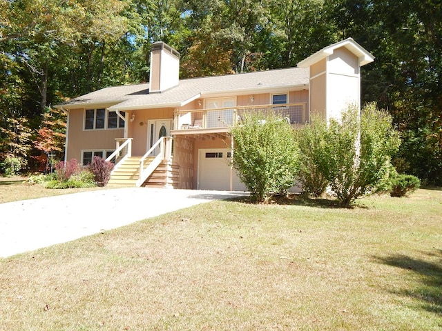 tri-level home with a garage and a front lawn