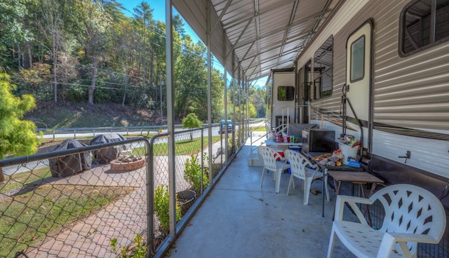view of patio / terrace featuring fence and view of scattered trees