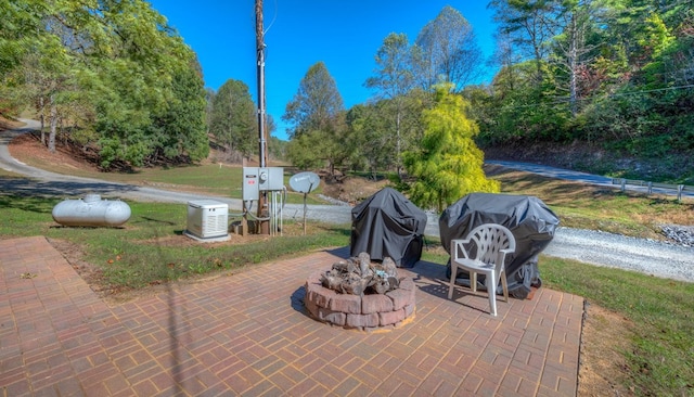 view of patio featuring grilling area and a fire pit