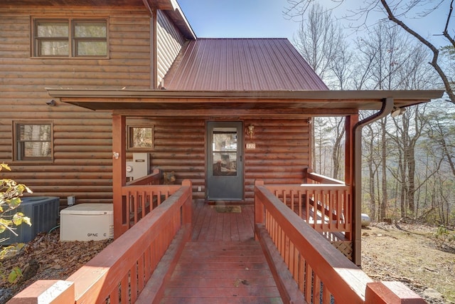 property entrance with cooling unit and metal roof