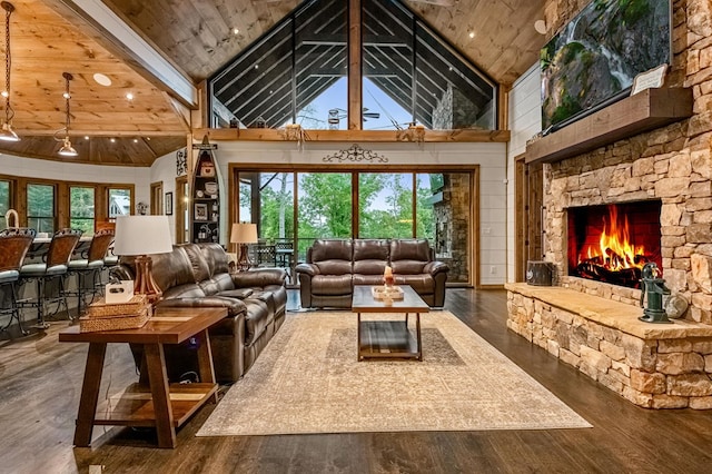 living room featuring wood-type flooring, high vaulted ceiling, wooden ceiling, and a stone fireplace