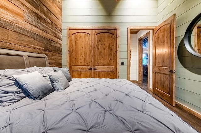 unfurnished bedroom with wooden walls and wood-type flooring