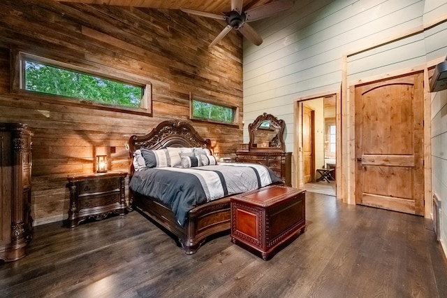 bedroom featuring ceiling fan, wood walls, wood ceiling, and dark wood-type flooring