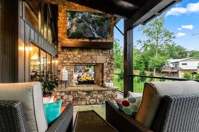 balcony with an outdoor stone fireplace