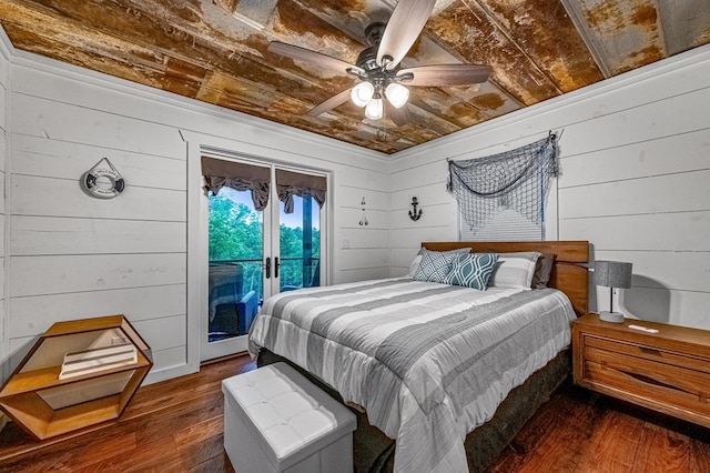 bedroom featuring access to exterior, dark wood-type flooring, wooden ceiling, and wood walls