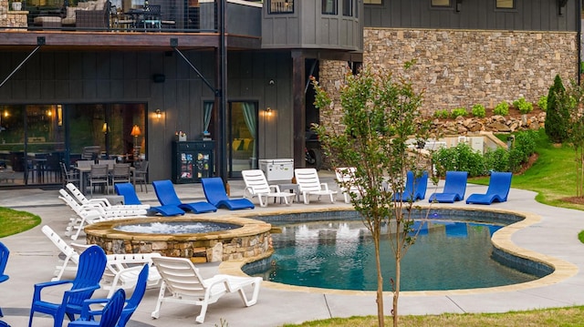 view of swimming pool with an in ground hot tub and a patio