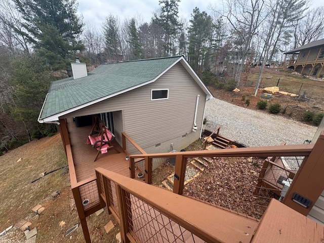 exterior space featuring a shingled roof, a chimney, crawl space, and a deck