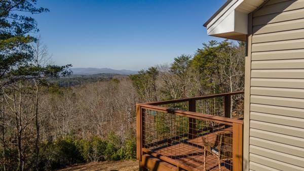 view of gate with a forest view