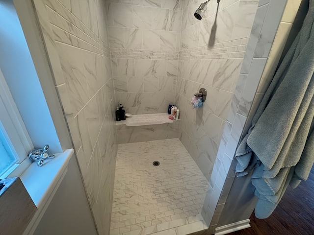 bathroom with a tile shower