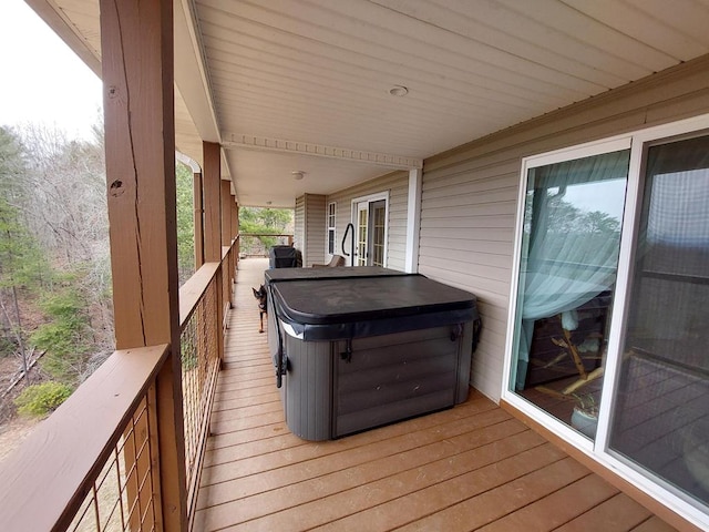 wooden deck featuring a hot tub