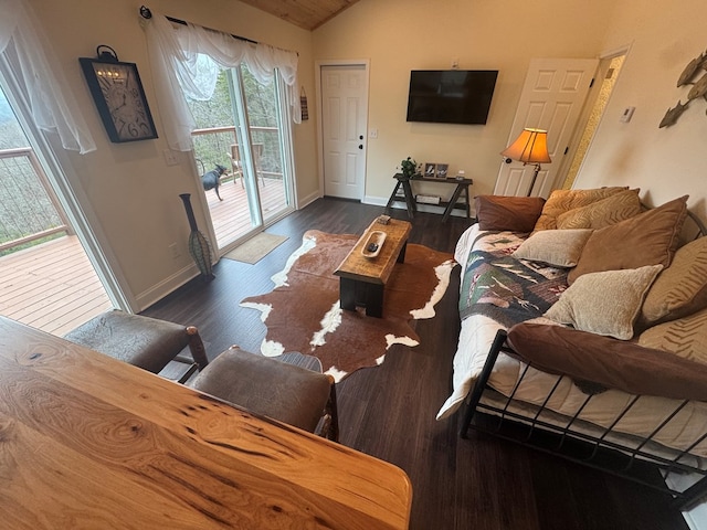 living room with baseboards, vaulted ceiling, and dark wood-type flooring