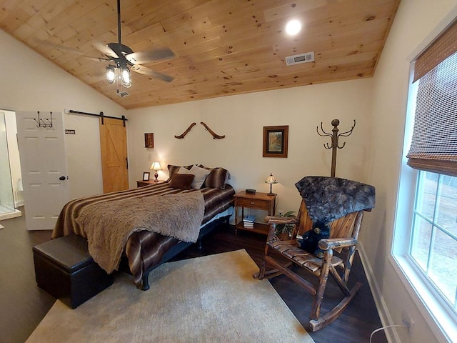 bedroom featuring lofted ceiling, a barn door, wooden ceiling, wood finished floors, and visible vents