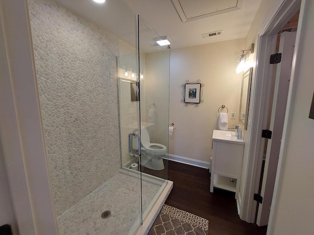 full bath featuring visible vents, toilet, wood finished floors, vanity, and a shower stall