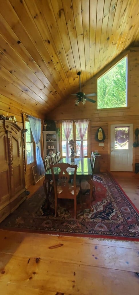 dining area featuring light hardwood / wood-style flooring, wooden ceiling, lofted ceiling, and plenty of natural light